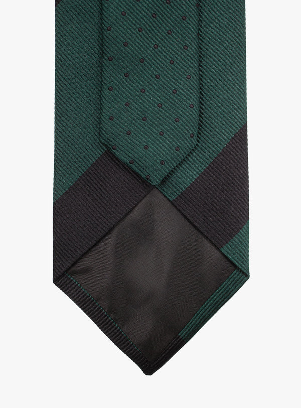 Green and black patterned tie on a white background