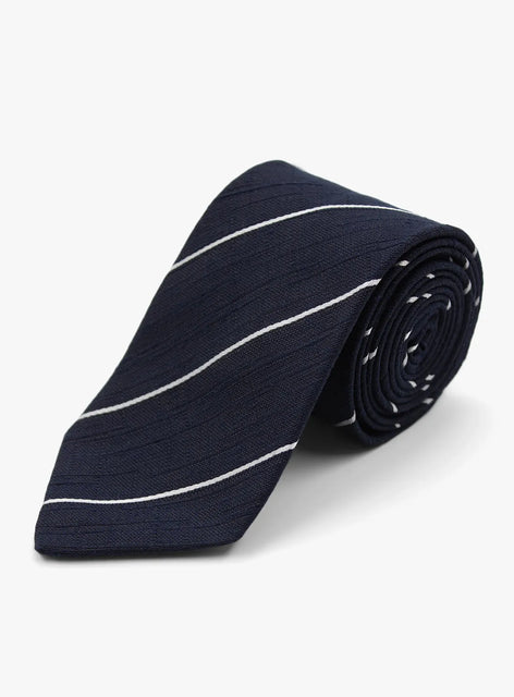 Navy blue tie with white stripes rolled up on a white background