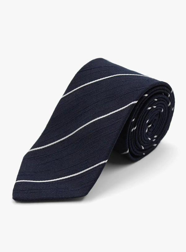 Navy blue tie with white stripes rolled up on a white background