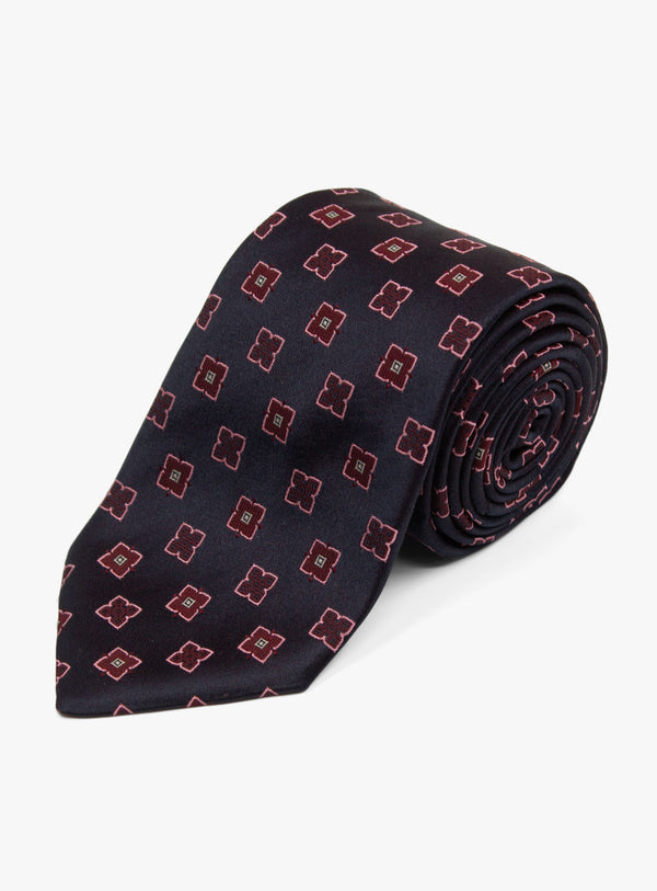 The Bottinelli Nero Rosso Geo Navy Silk Tie rolled up