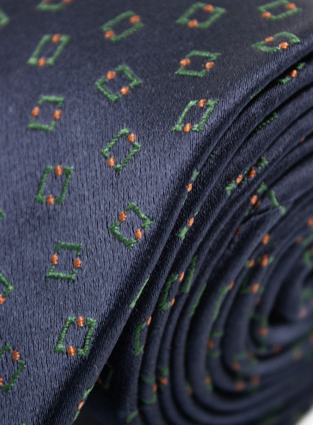 Close-up of the Bottinelli Bosco Geo Navy Silk Tie rolled up