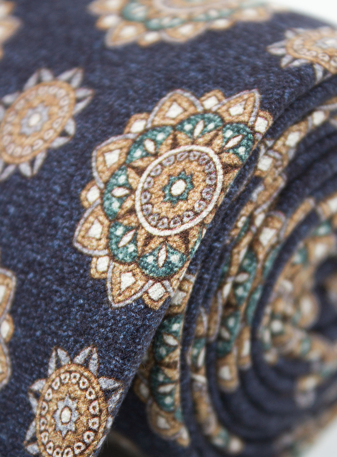 Close-up of the Bottinelli Notte Medallion Navy Silk Tie rolled up