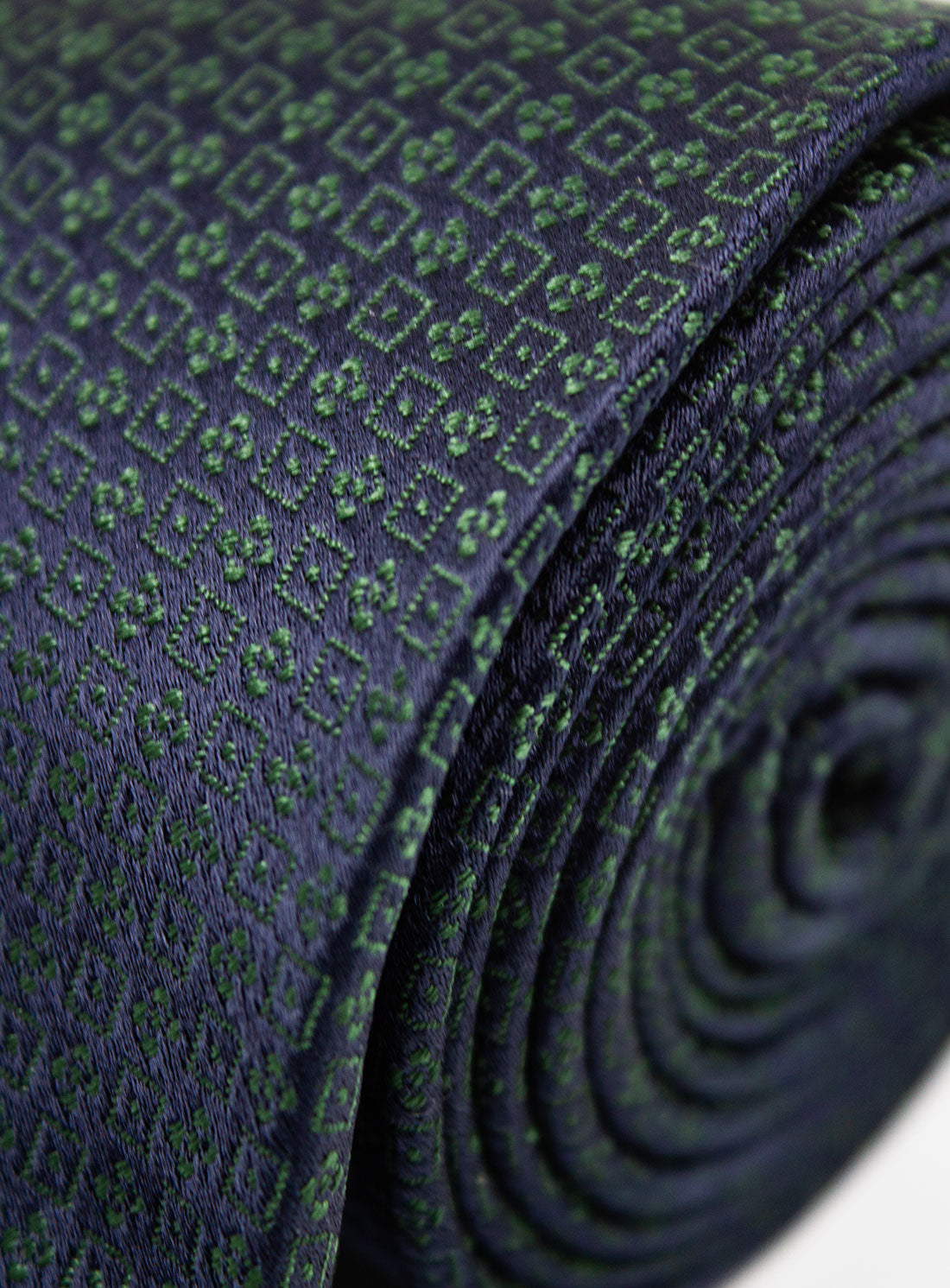 Close up of the Bottinelli Notte Verde Navy Silk Tie rolled up