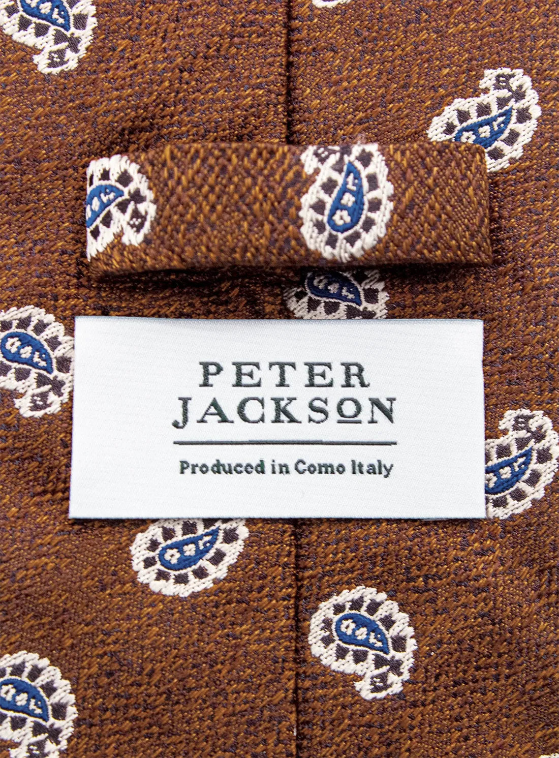 Brown patterned tie with a 'Peter Jackson' label on a matching background