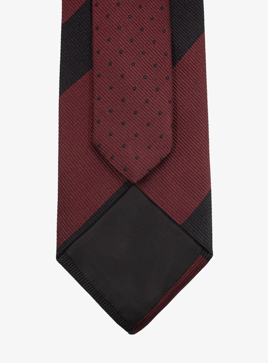 Red and black patterned tie on a white background