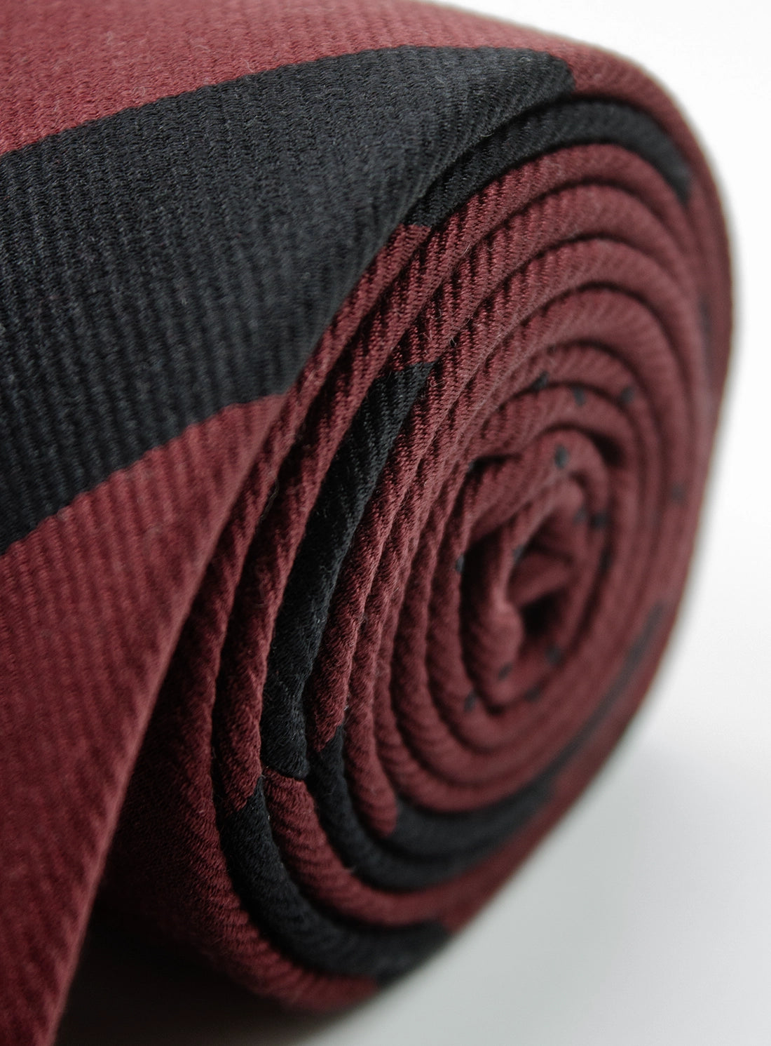 Roll of red and black fabric on a white background