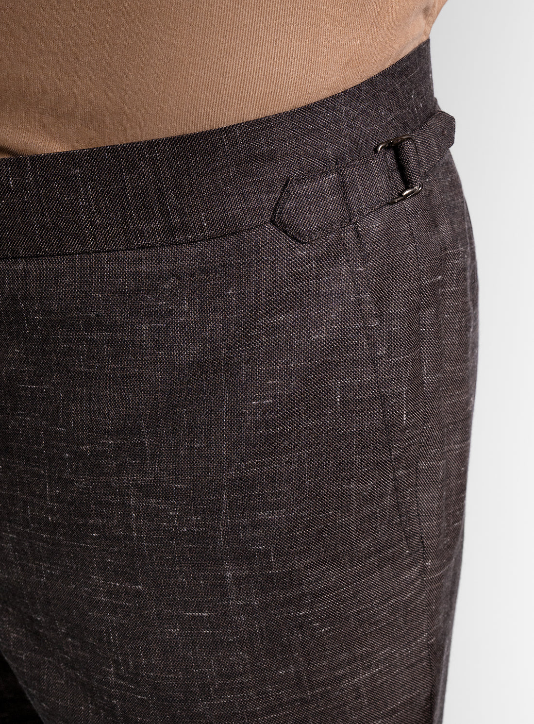 Close up of man wearing brown trousers on a white background