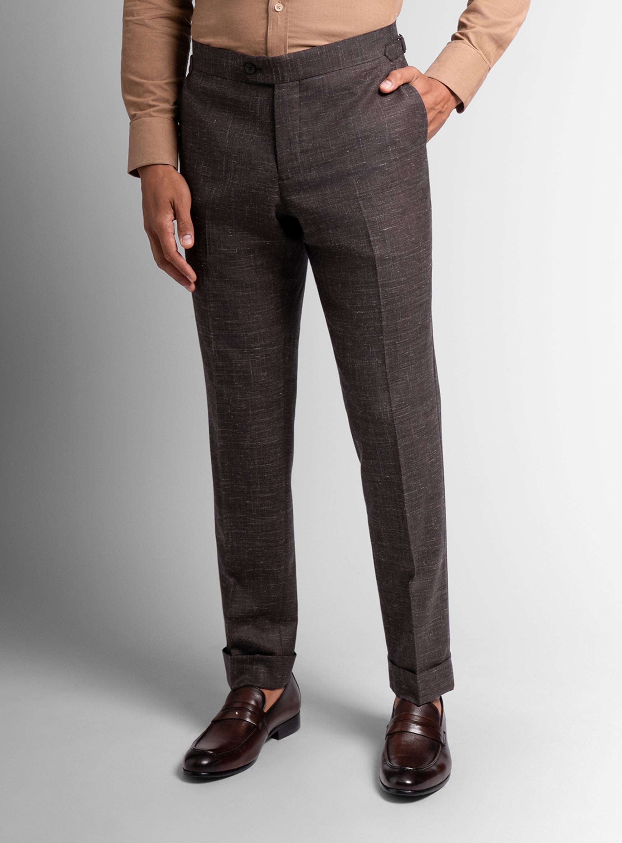 Brown pants worn by a person on a light gray background