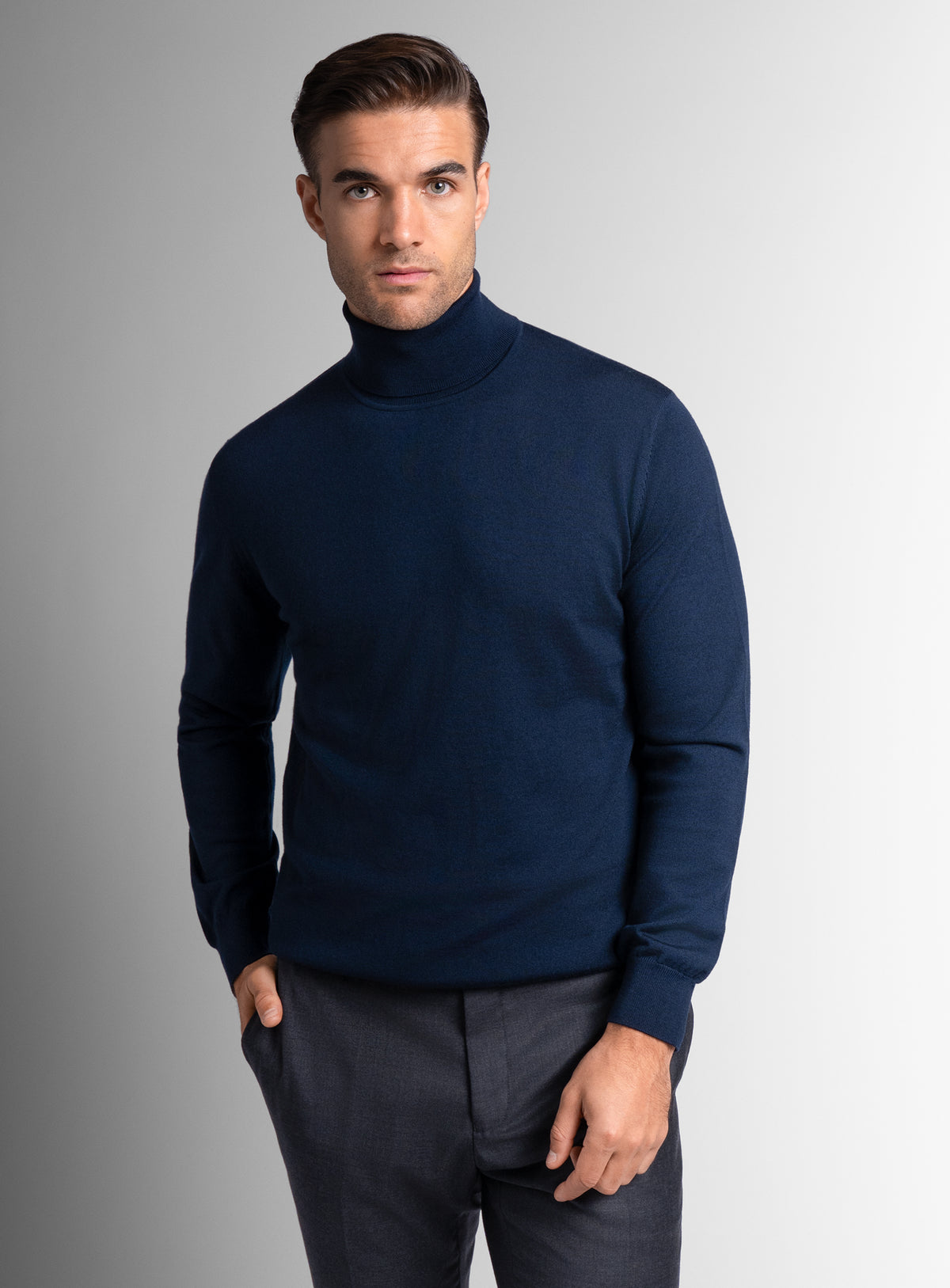 A man wearing the Merino Wool Navy Turtleneck Knit