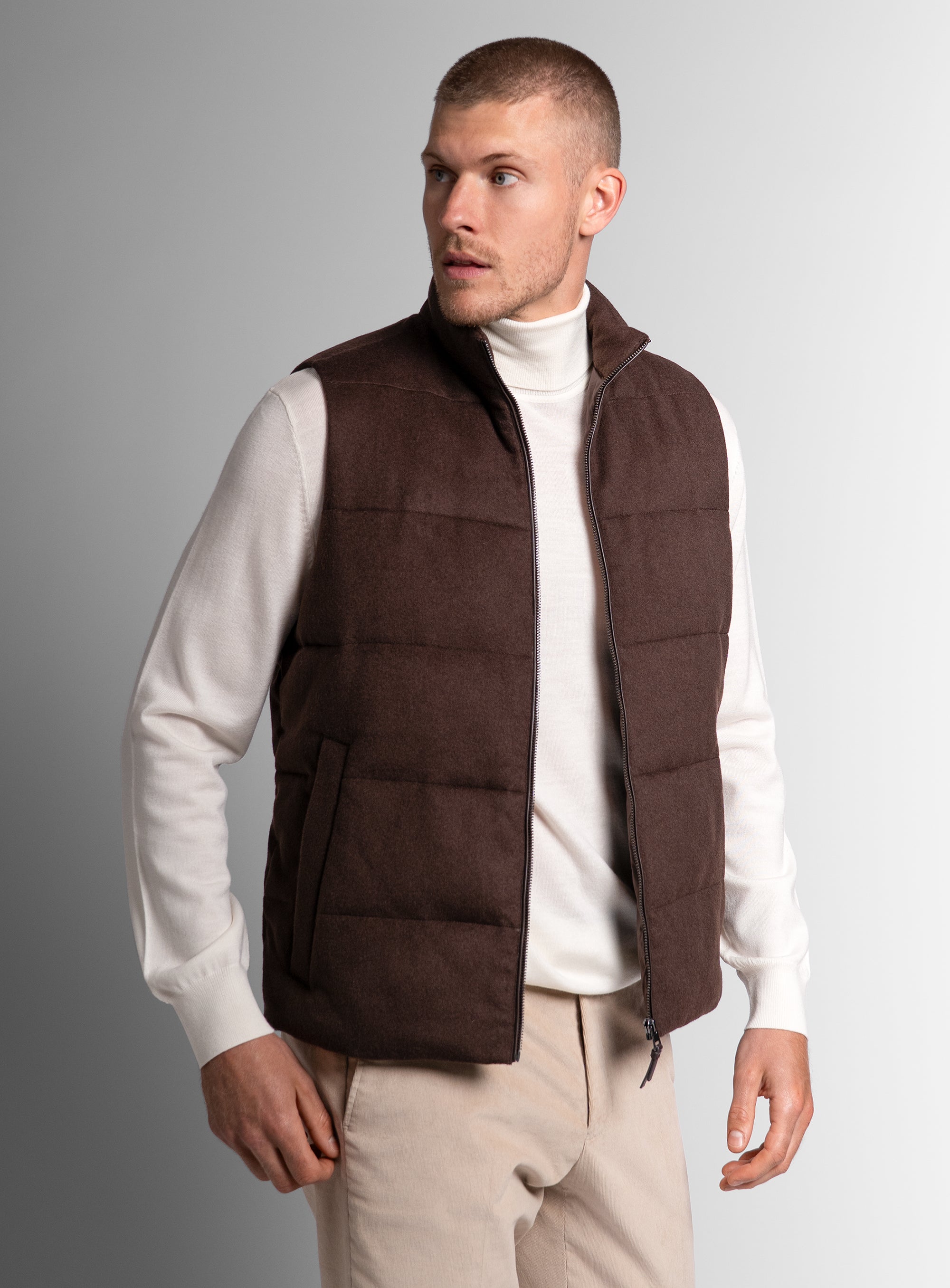 Man looking to his side, wearing the Gandolfi Wool Pile Brown Puffer Vest
