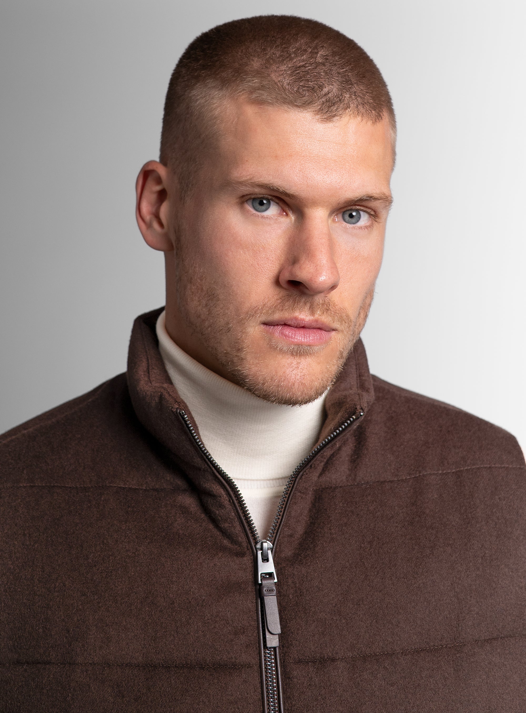 Close-up of a man wearing the Gandolfi Wool Pile Brown Puffer Vest