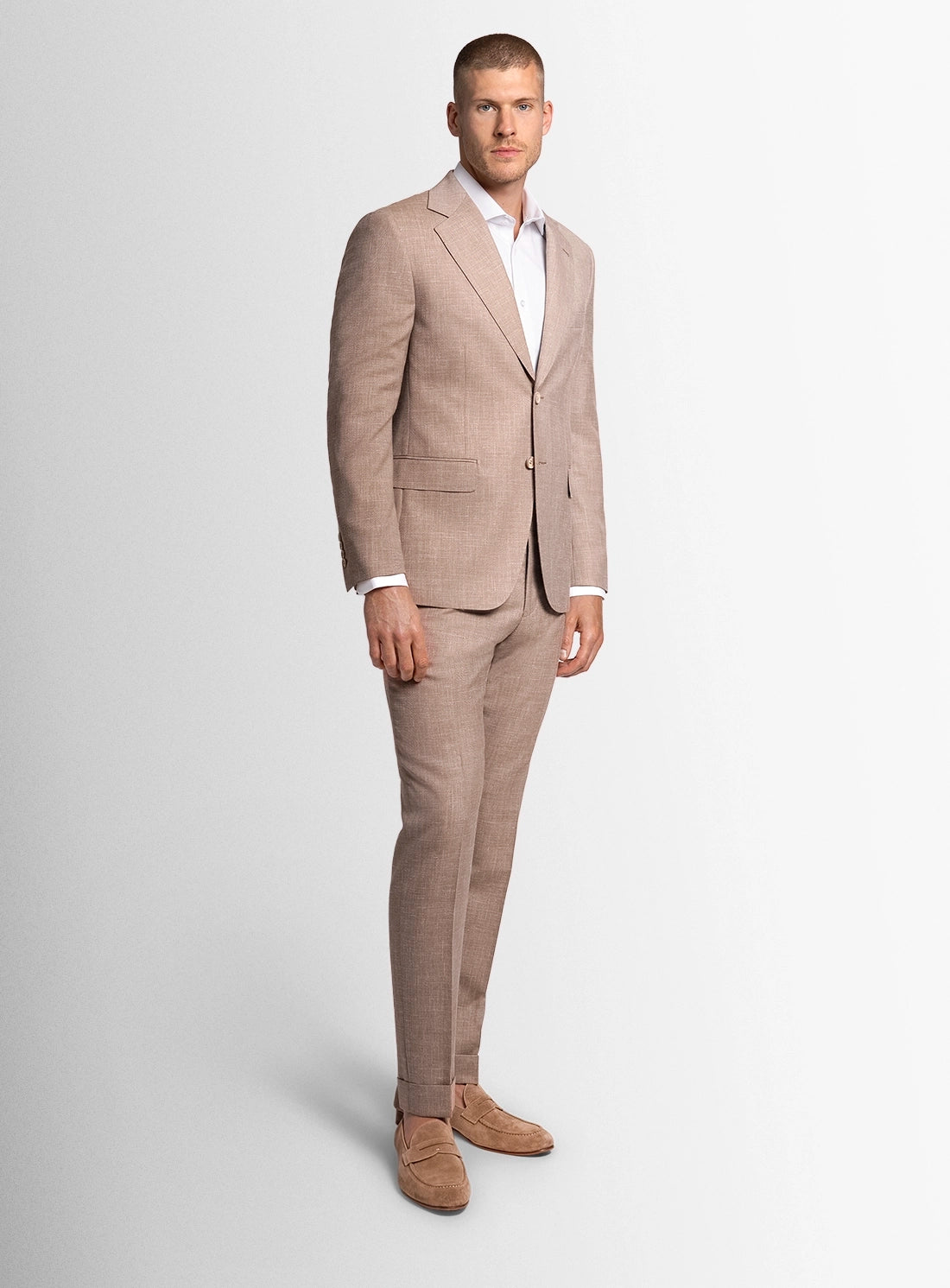 Man wearing a beige suit on a white background