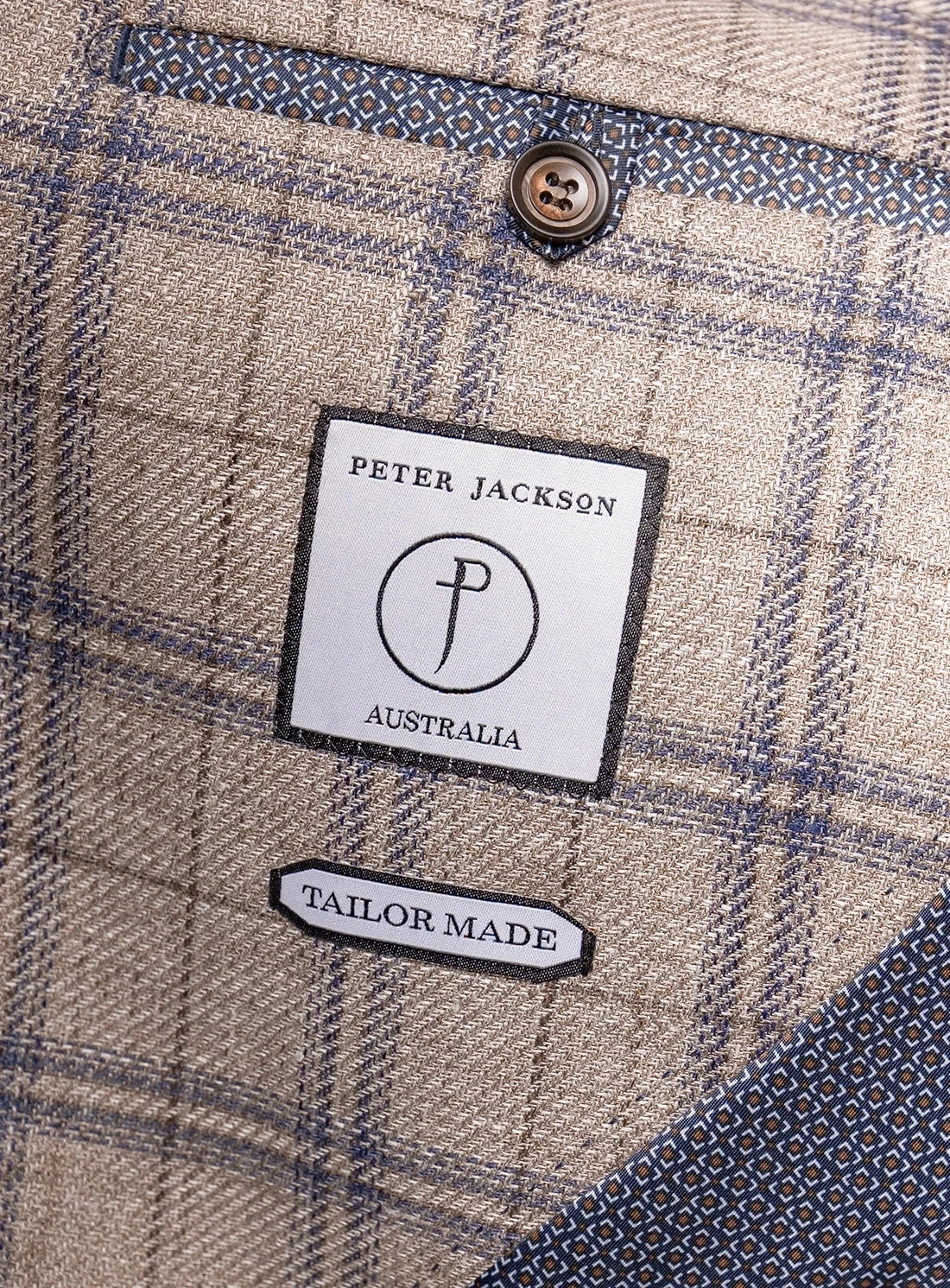 Close-up of a plaid fabric with a Peter Jackson Australia label.