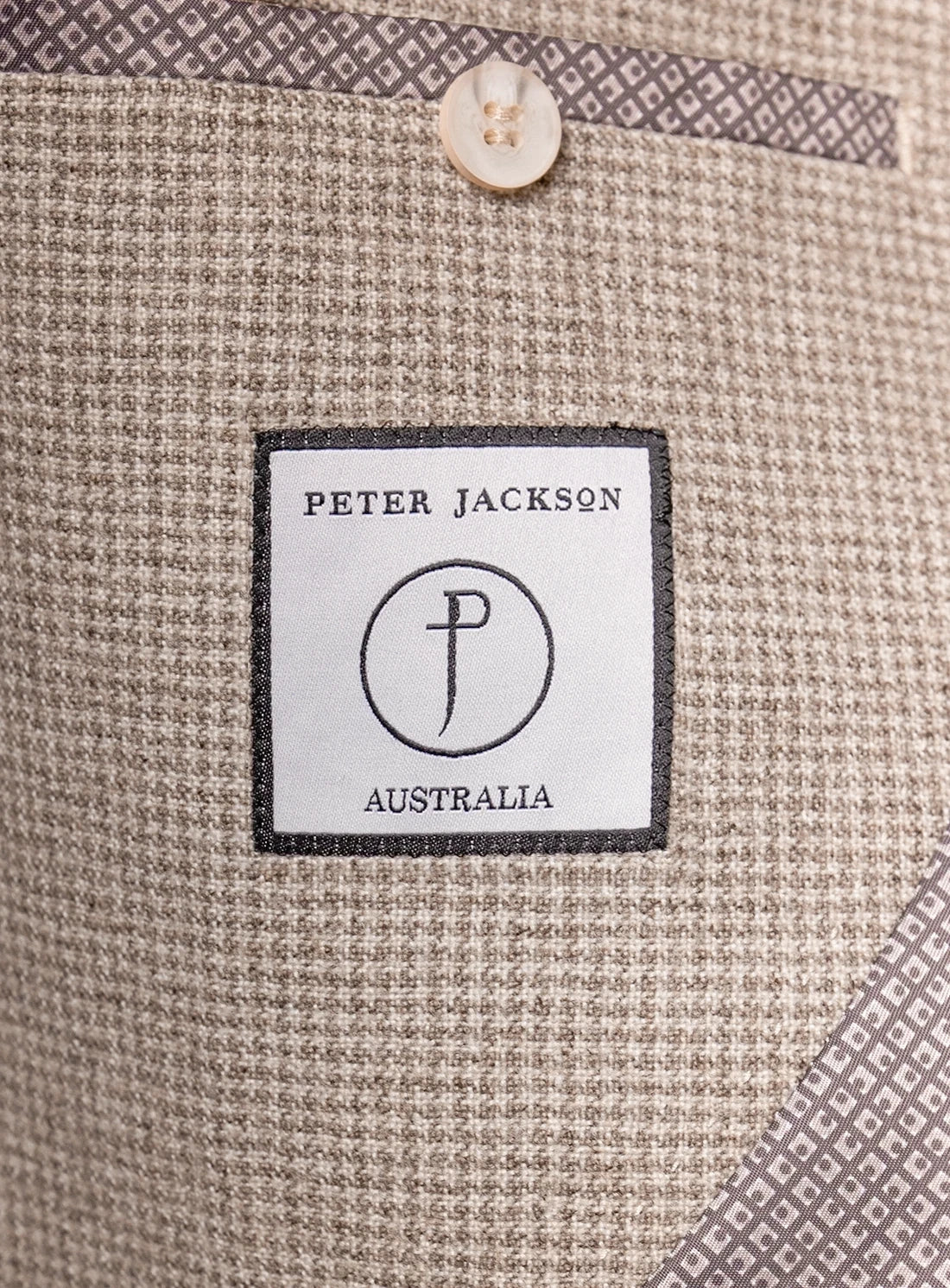 Close-up of a 'Peter Jackson Australia' label on textured fabric.