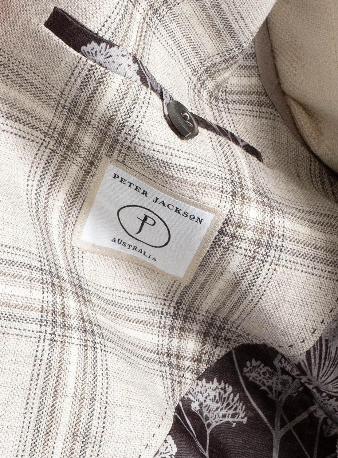 Close-up of a textured fabric with a brand label for Peter Jackson Australia.