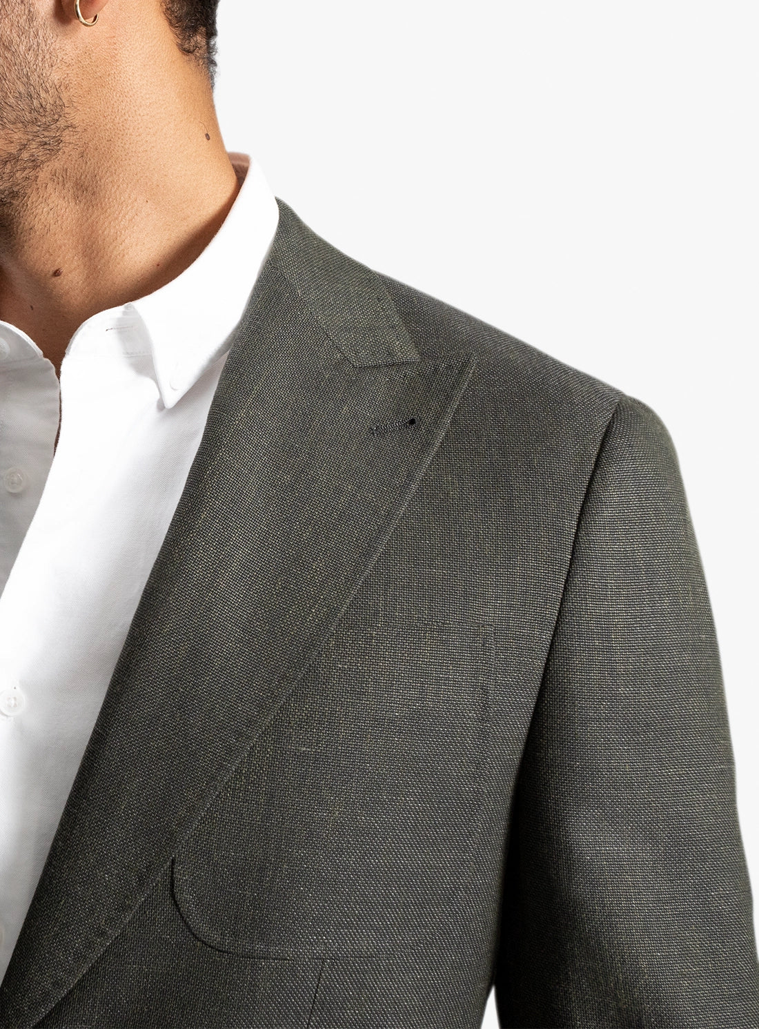 Gray suit jacket worn by a person on a white background