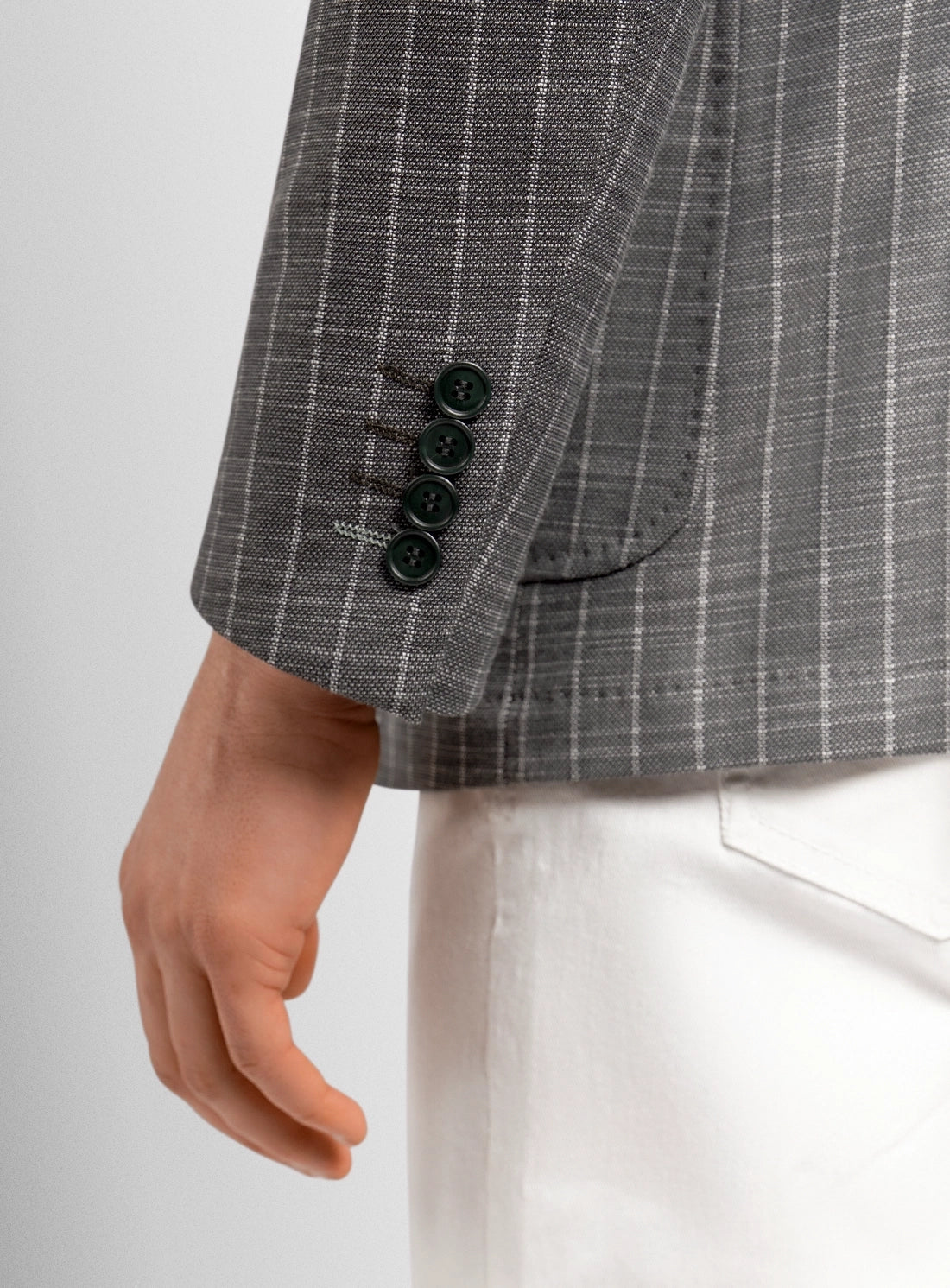 Gray checkered suit jacket with black buttons on a white background