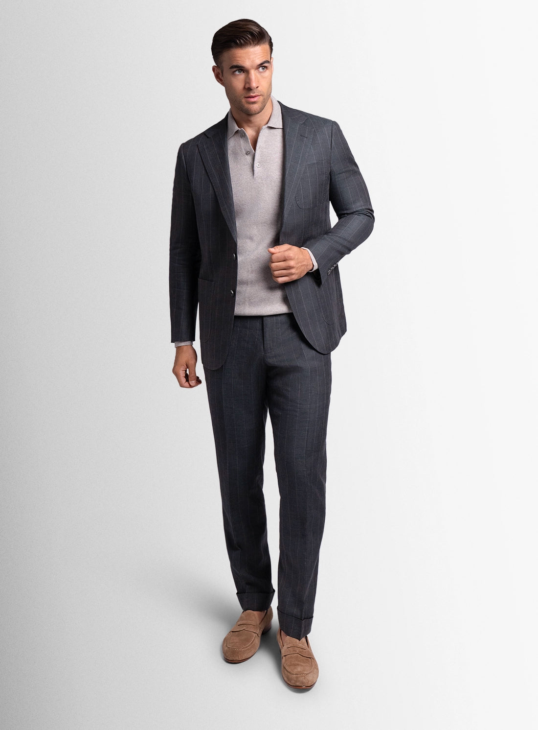 Man wearing a gray suit with a white shirt on a light gray background