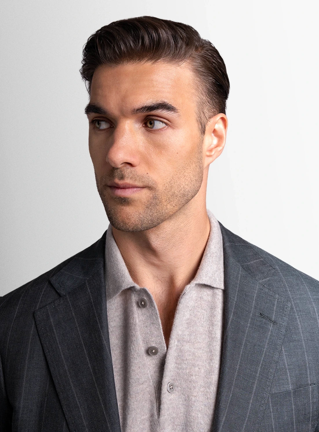Man wearing a gray suit with a white background
