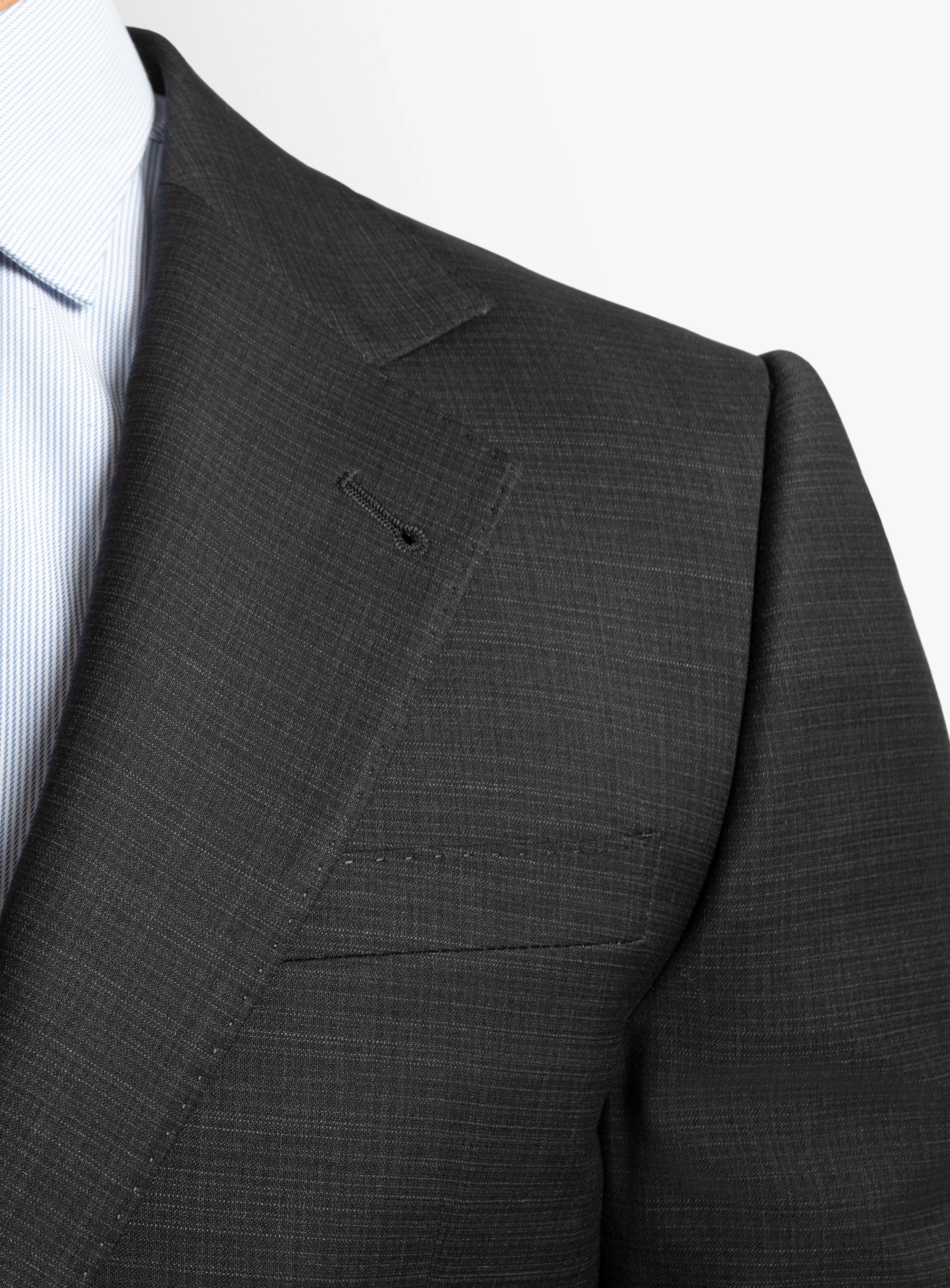 Gray suit jacket on a mannequin with a white shirt underneath