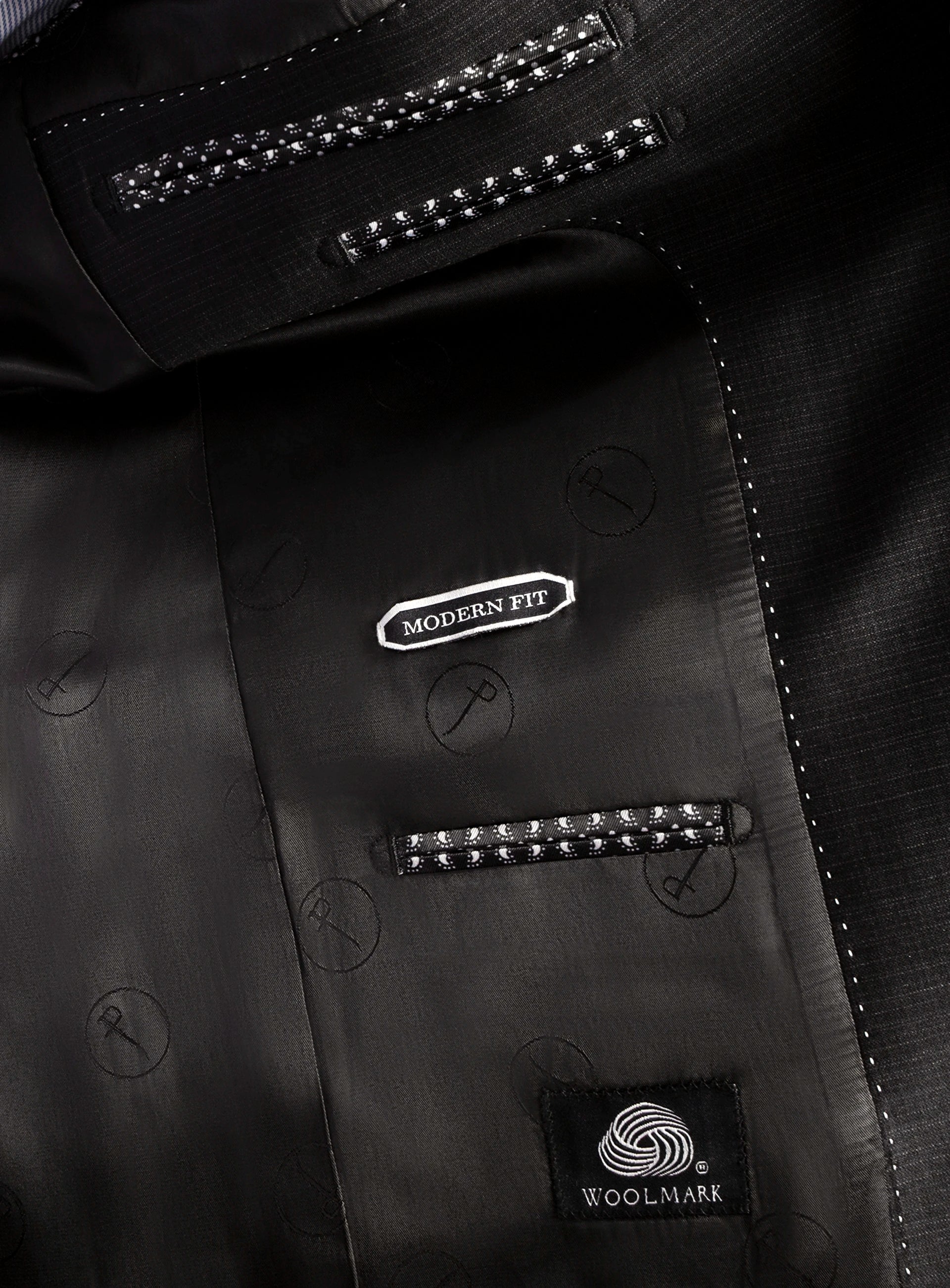 Close-up of a black suit jacket with 'Modern Fit' and 'Woolmark' labels.