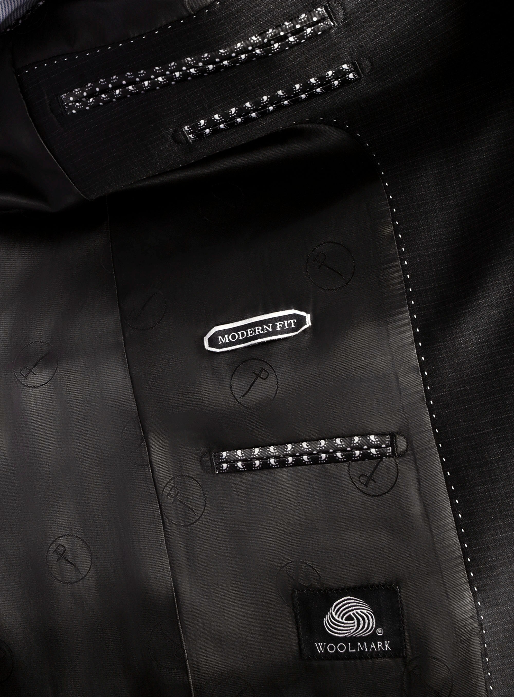 Close-up of a black suit jacket with 'Modern Fit' and 'Woolmark' labels.