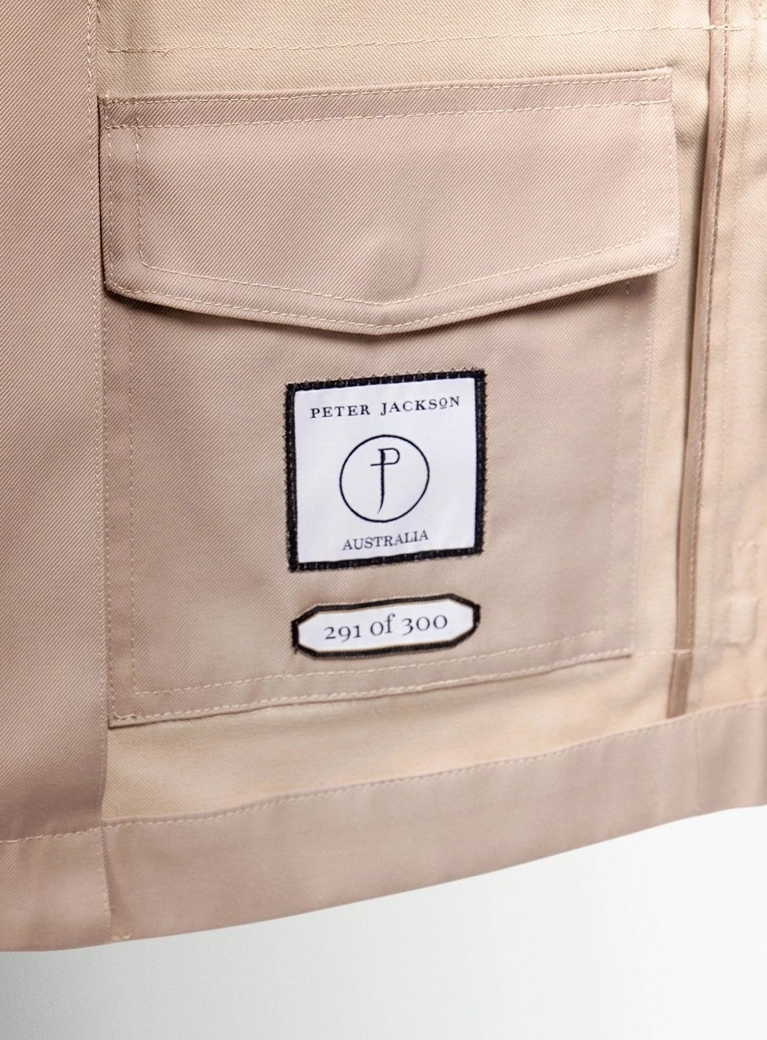 Close-up of a beige garment with a Peter Jackson Australia label.