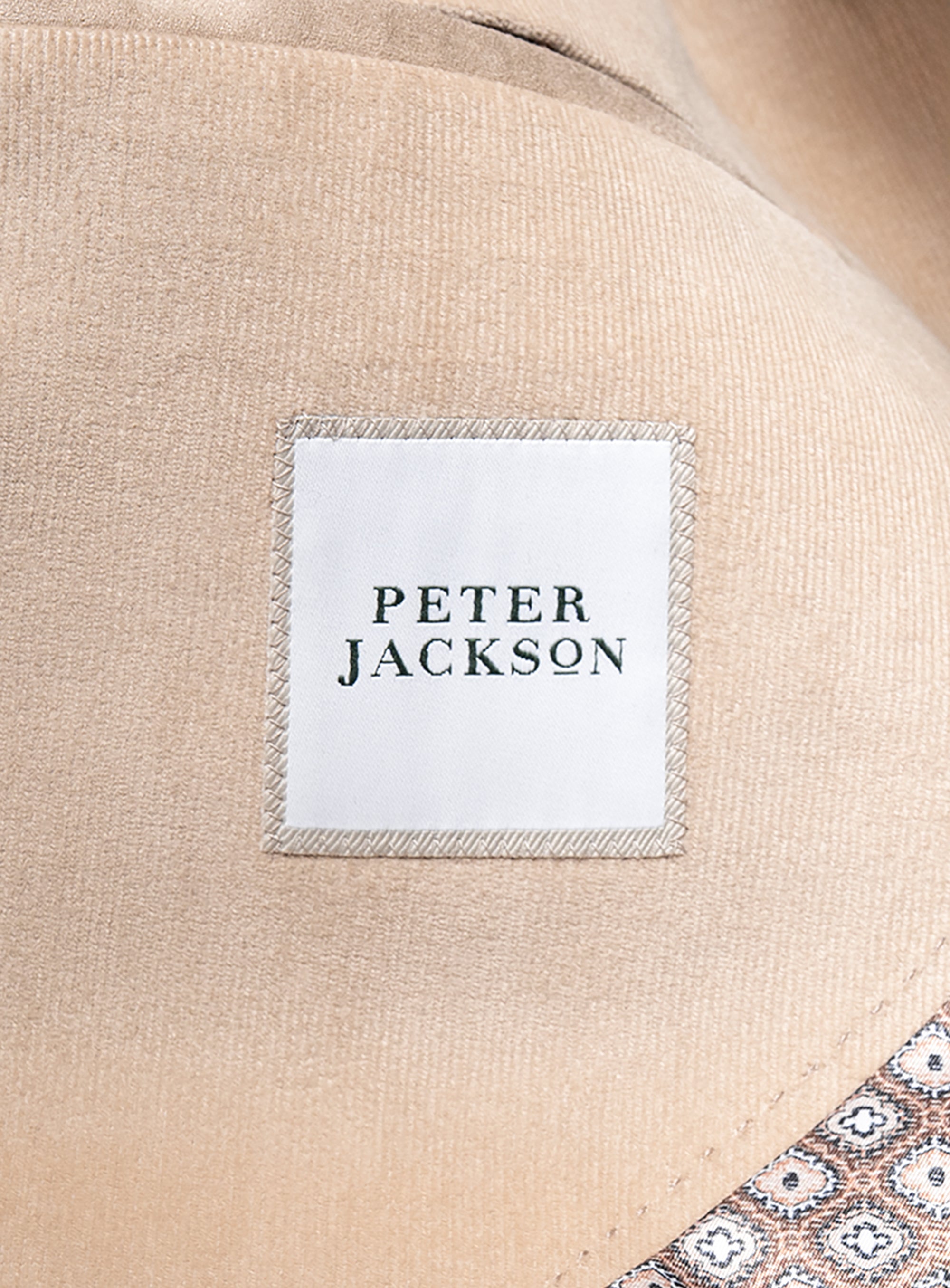Close-up of a beige fabric with a 'Peter Jackson' label.