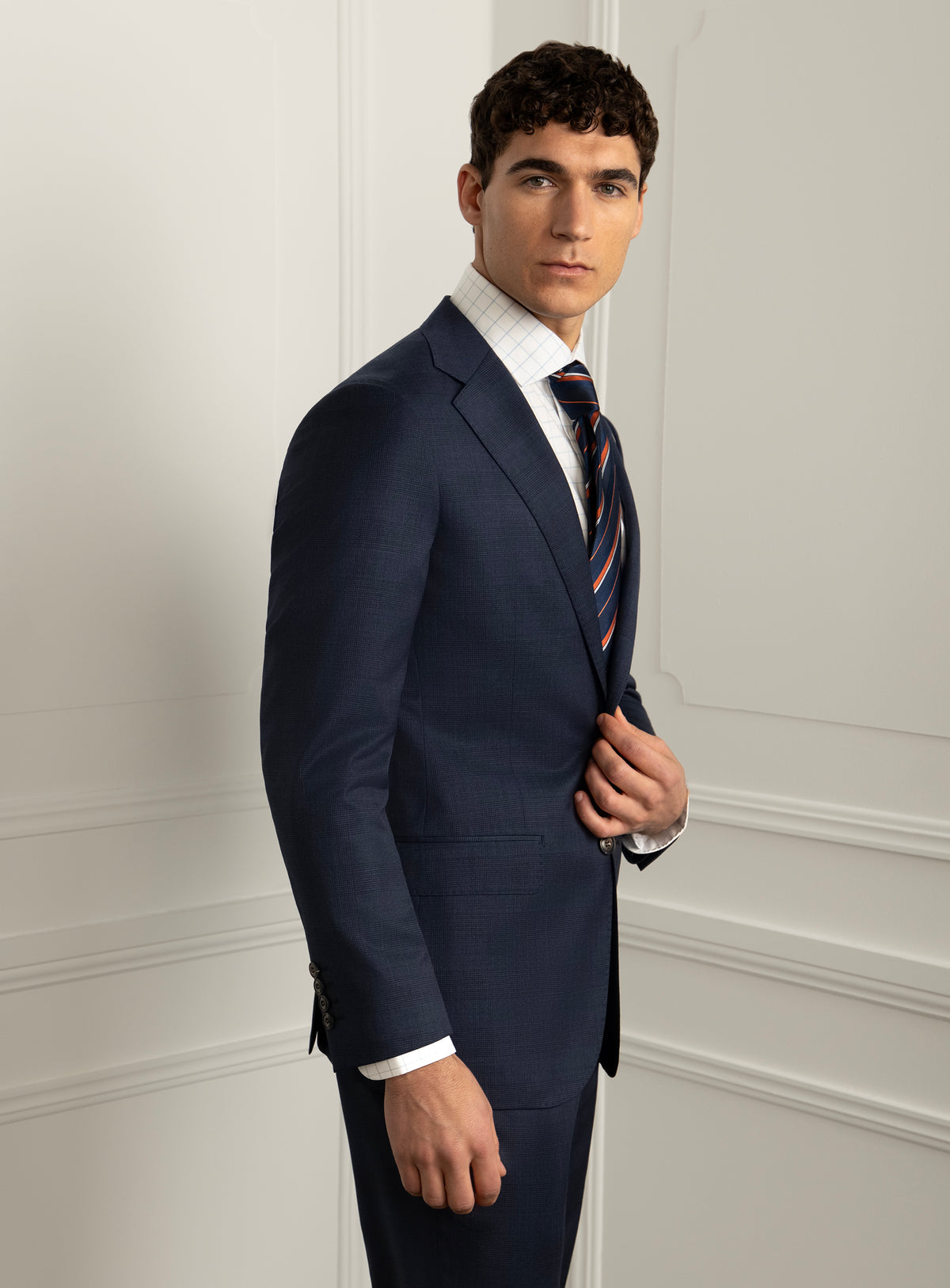 Pazzi Plaid Navy Suit - Model angled front view holding lapel