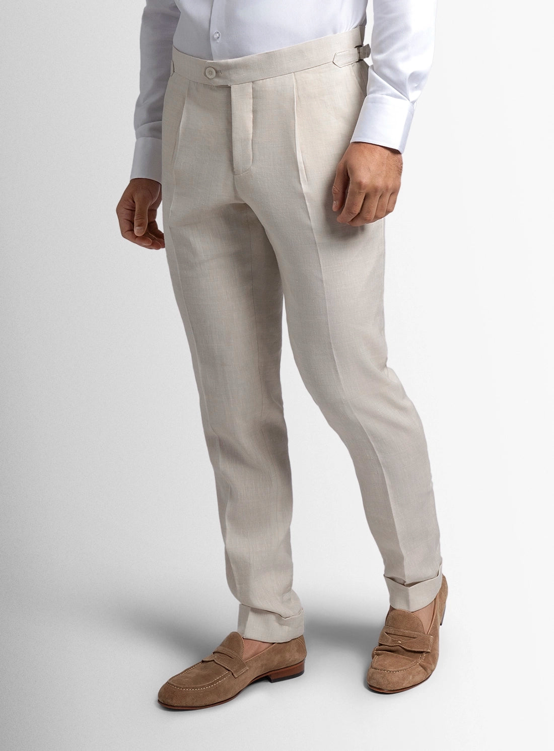 Light gray pants worn by a person on a white background