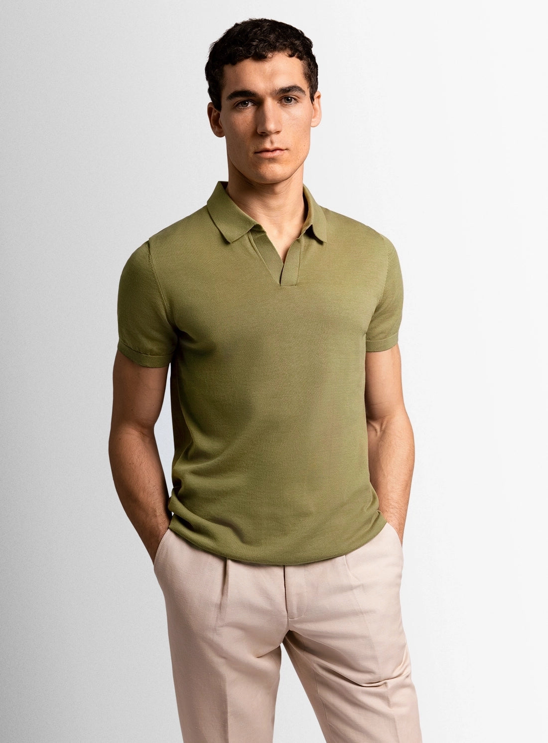 Green cotton polo shirt with a Peter Jackson label on a white background
