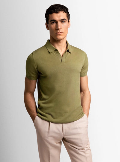 Green cotton polo shirt with a Peter Jackson label on a white background