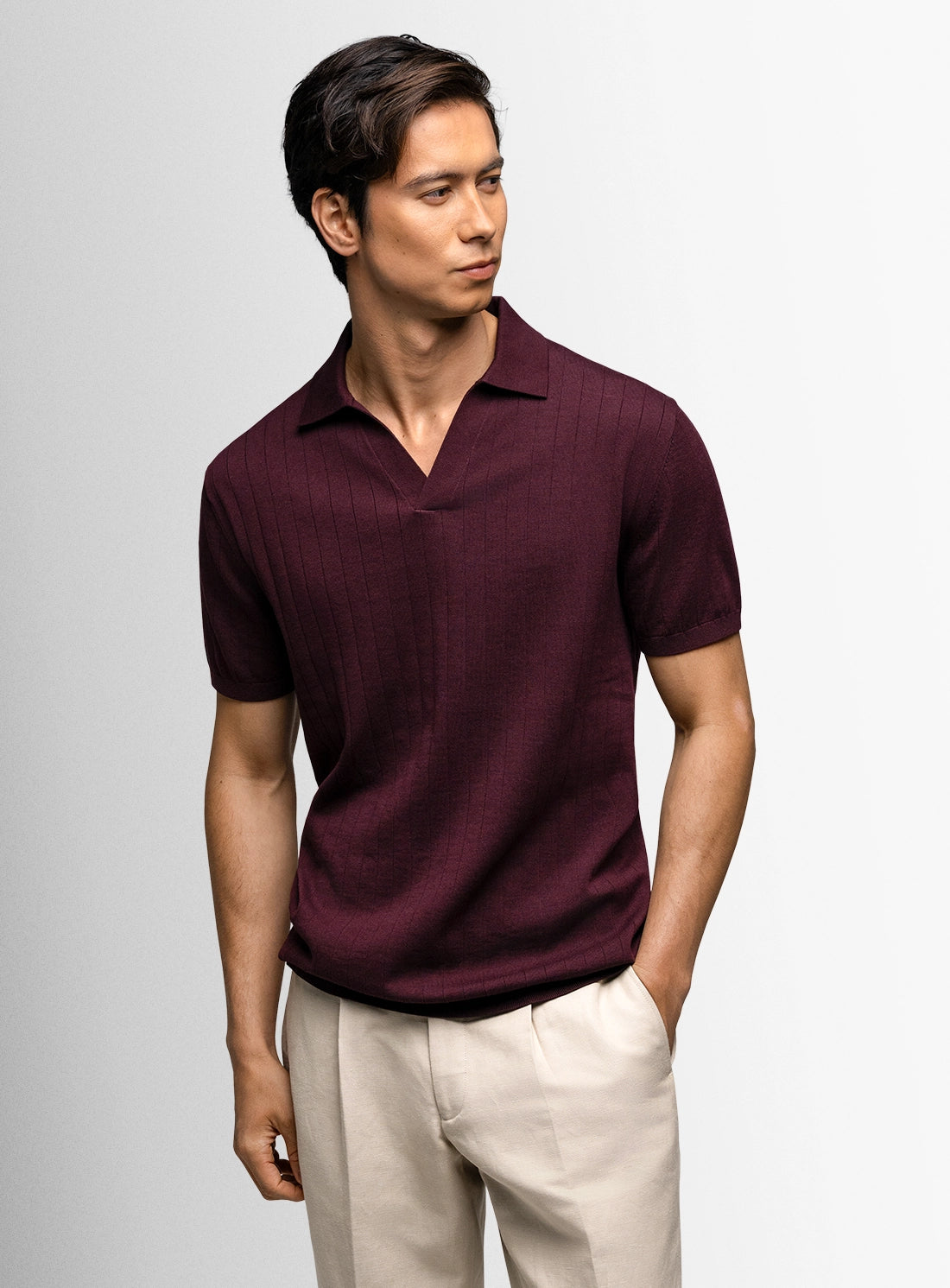 Man with red polo shirt and beige pants