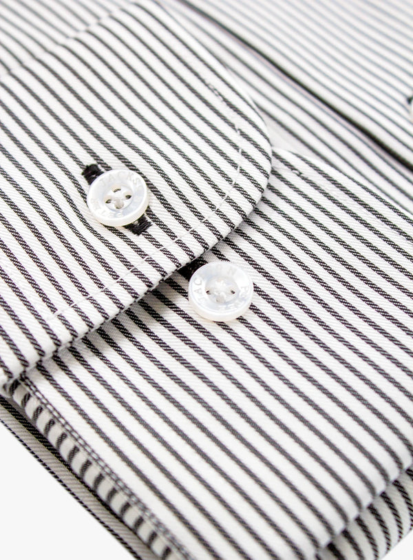 Close-up of a black and white striped shirt with buttons.