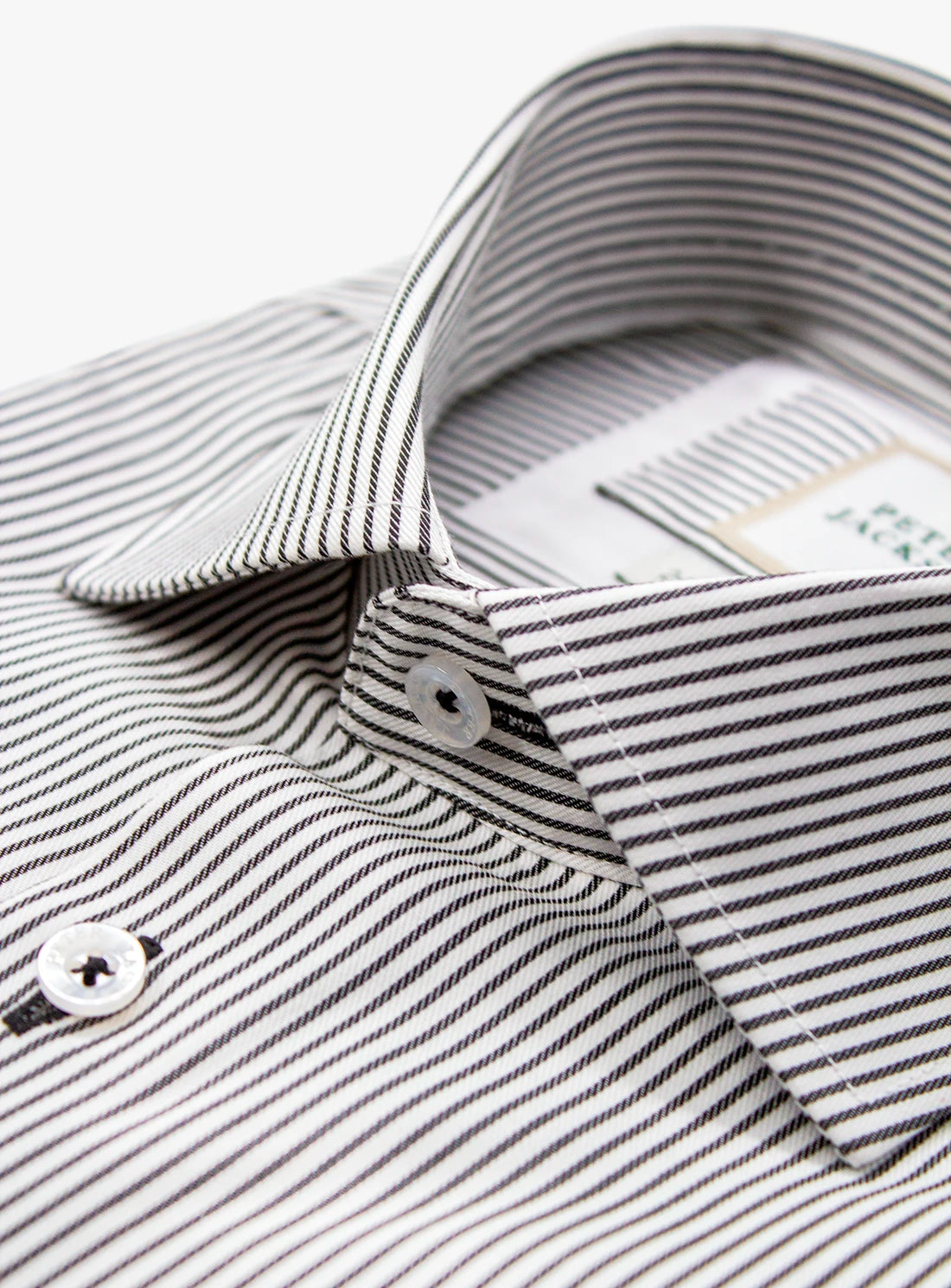 Close-up of a black and white striped shirt with collar and buttons.