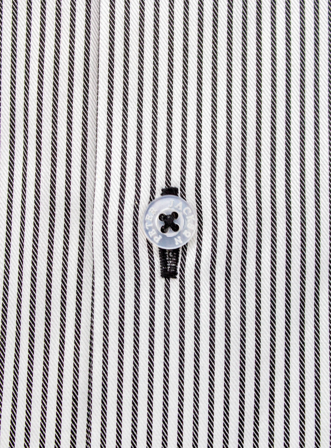 Close-up of a black and white striped shirt with a button.
