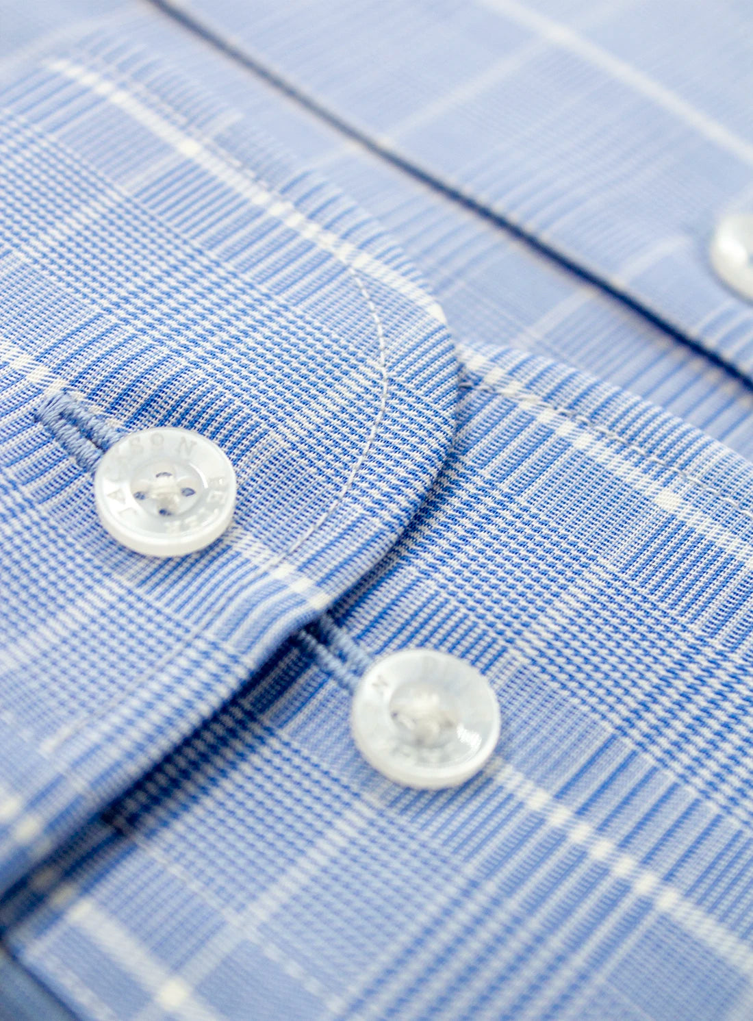 Close-up of a blue checkered shirt with buttons