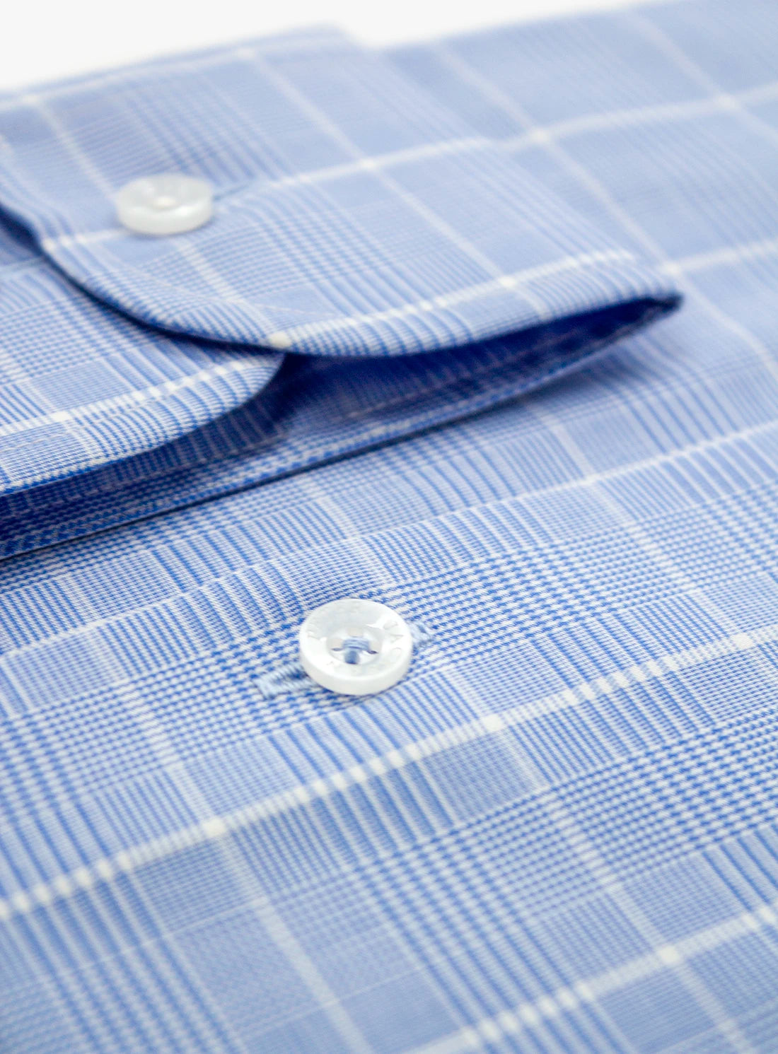 Close-up of a blue checkered shirt with buttons