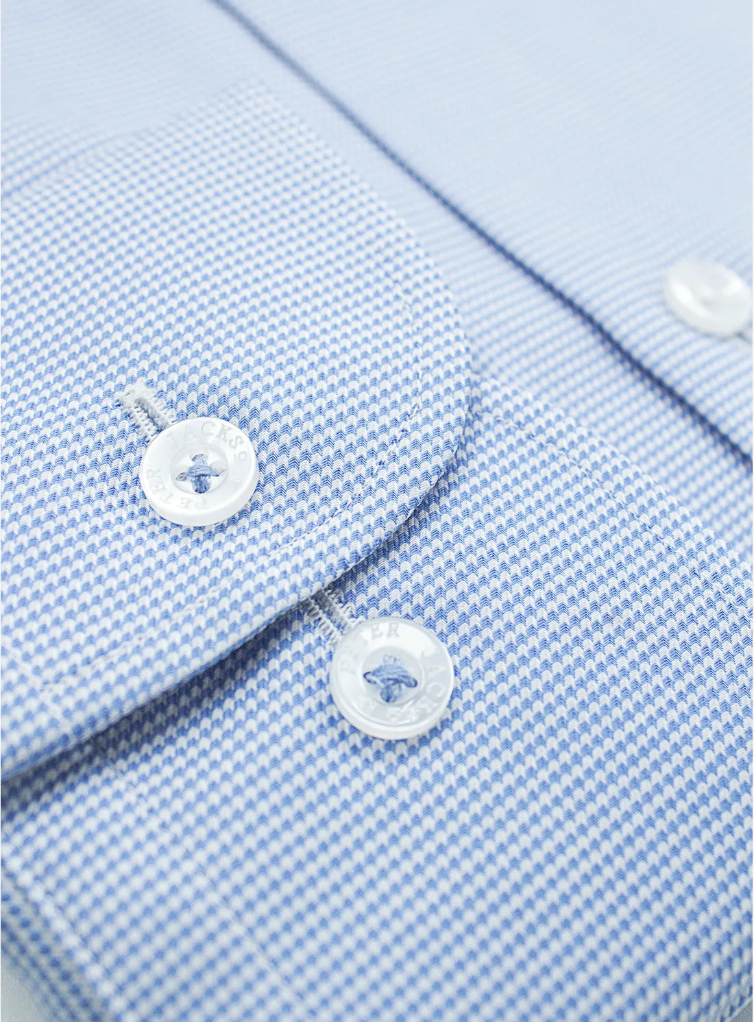 Blue dress shirt with a Peter Jackson label on a white background