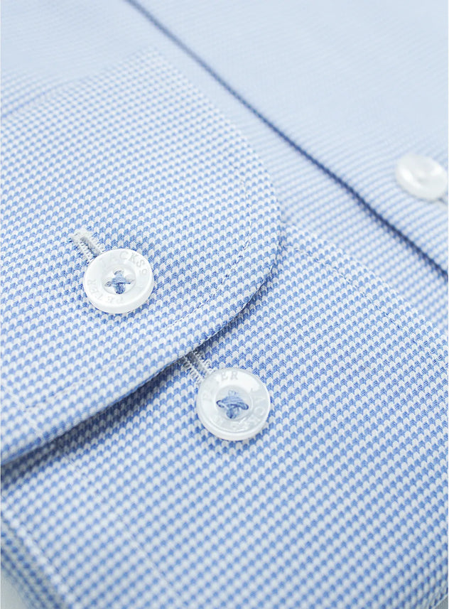 Blue dress shirt with a Peter Jackson label on a white background
