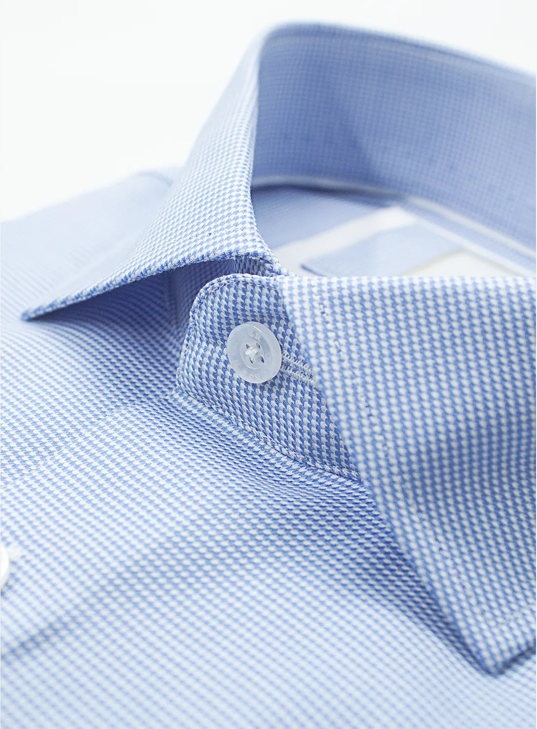 Blue dress shirt with a Peter Jackson label on a white background