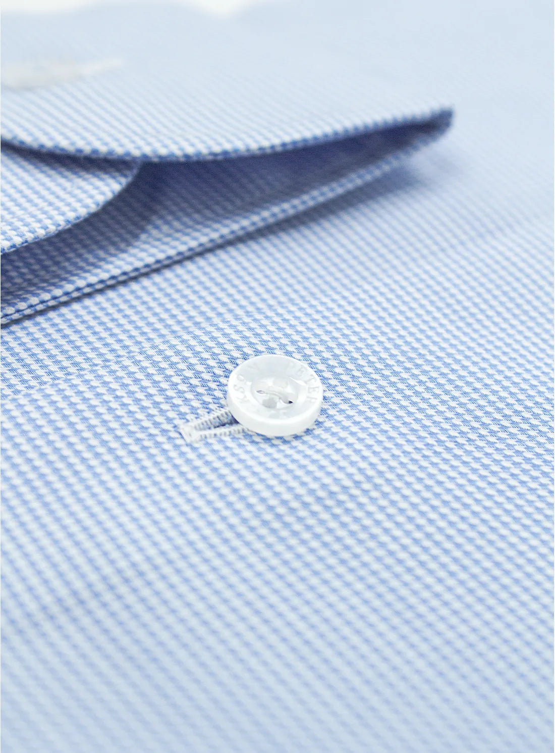 Blue dress shirt with a Peter Jackson label on a white background