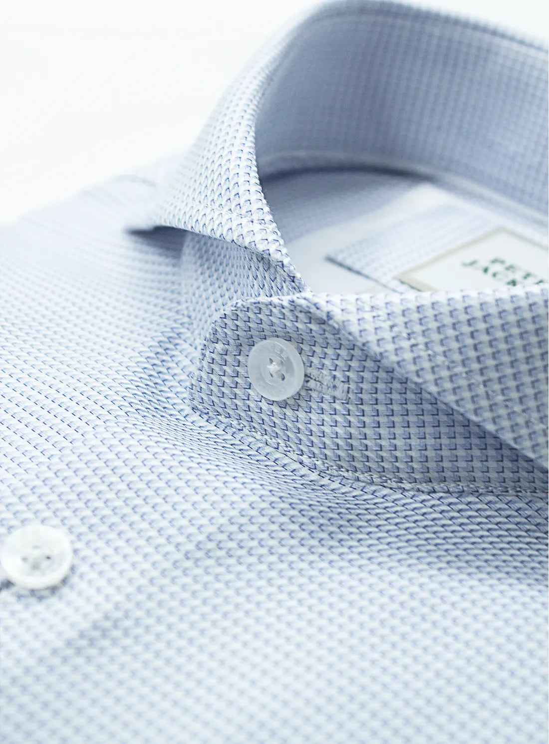 Pink dress shirt with a Peter Jackson label on a white background