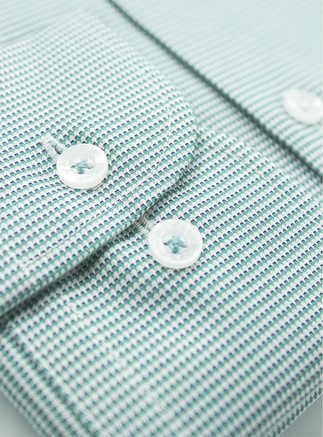 Green dress shirt with a Peter Jackson label on a white background