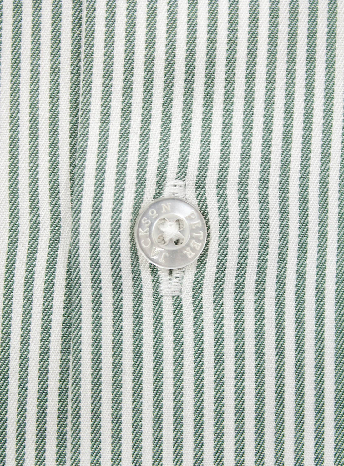 Close-up of a green and white striped shirt with a button, featuring the Hugo Boss logo.