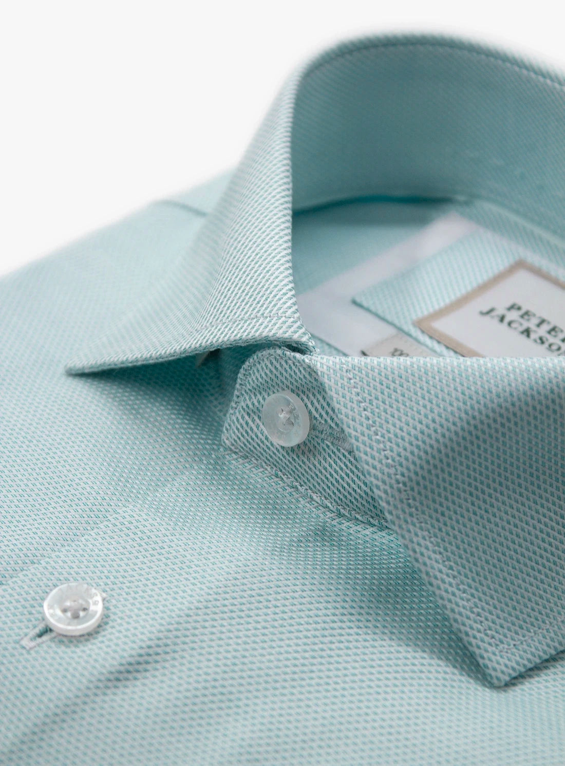 Light blue polo shirt with a brand label on a white background