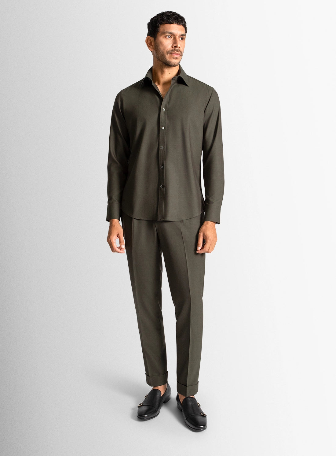 Man wearing a green suit on a white background