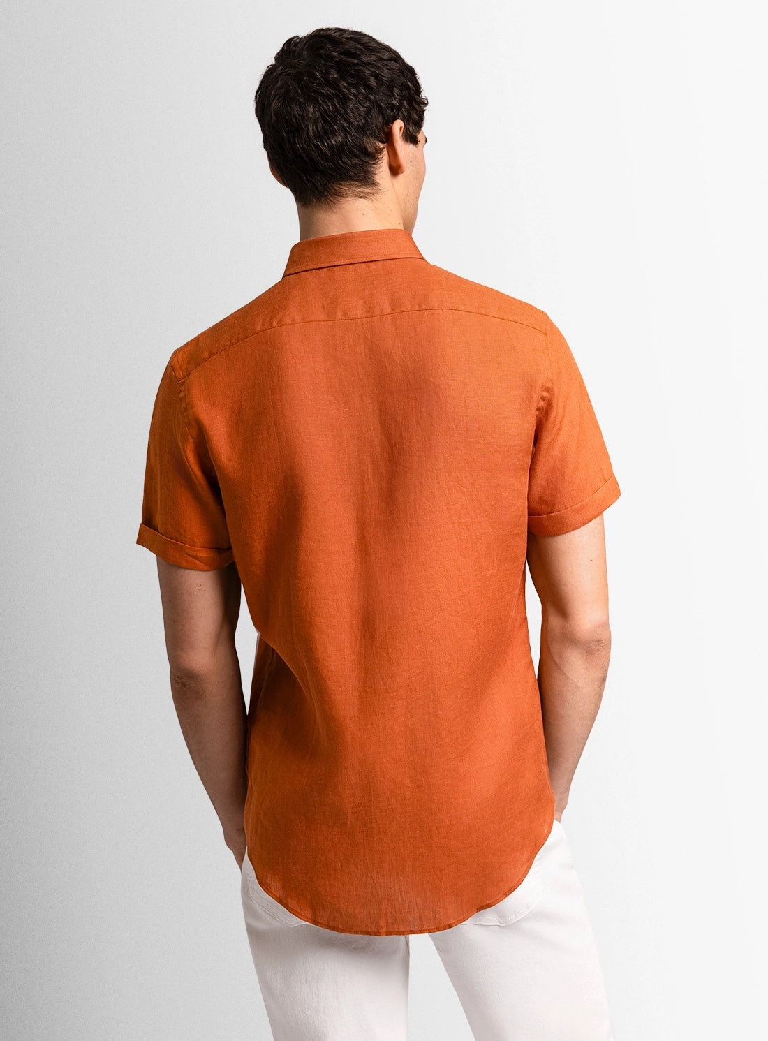 Orange dress shirt with a Peter Jackson label on a white background