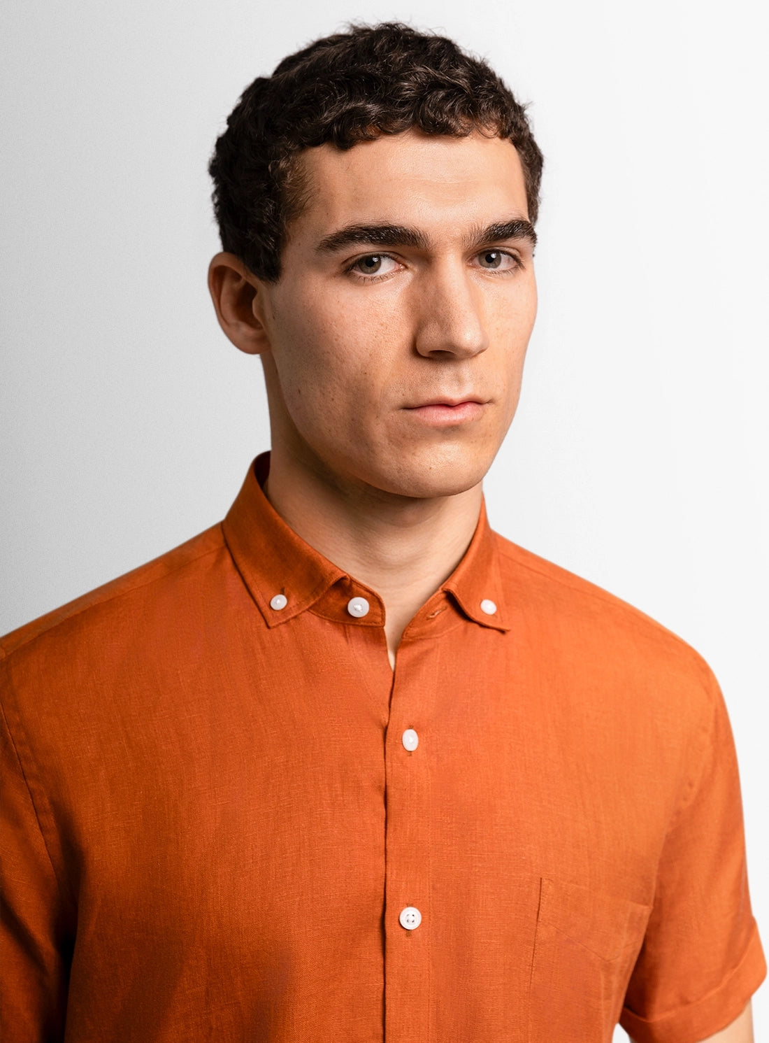 Orange dress shirt with a Peter Jackson label on a white background
