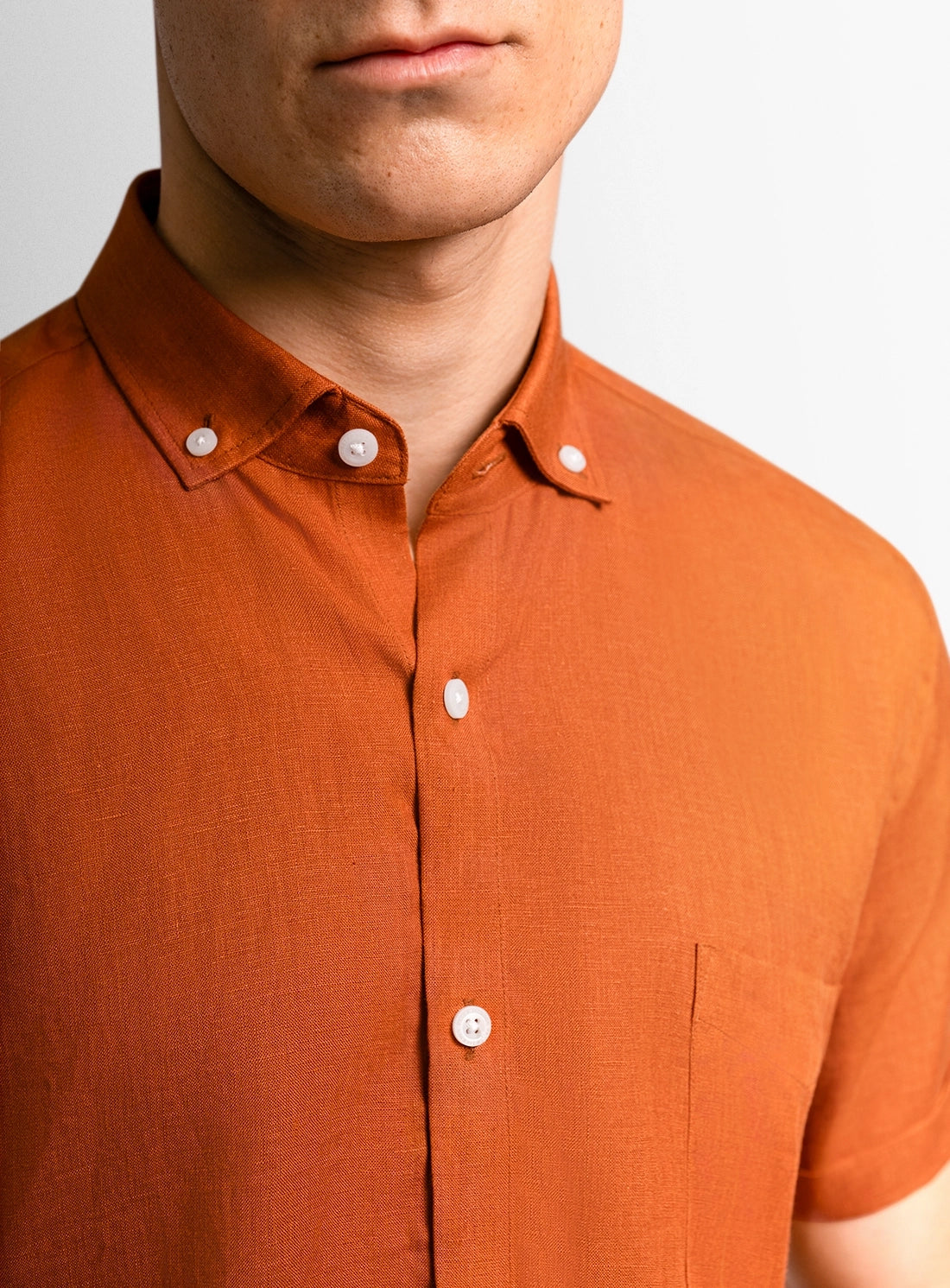 Orange dress shirt with a Peter Jackson label on a white background